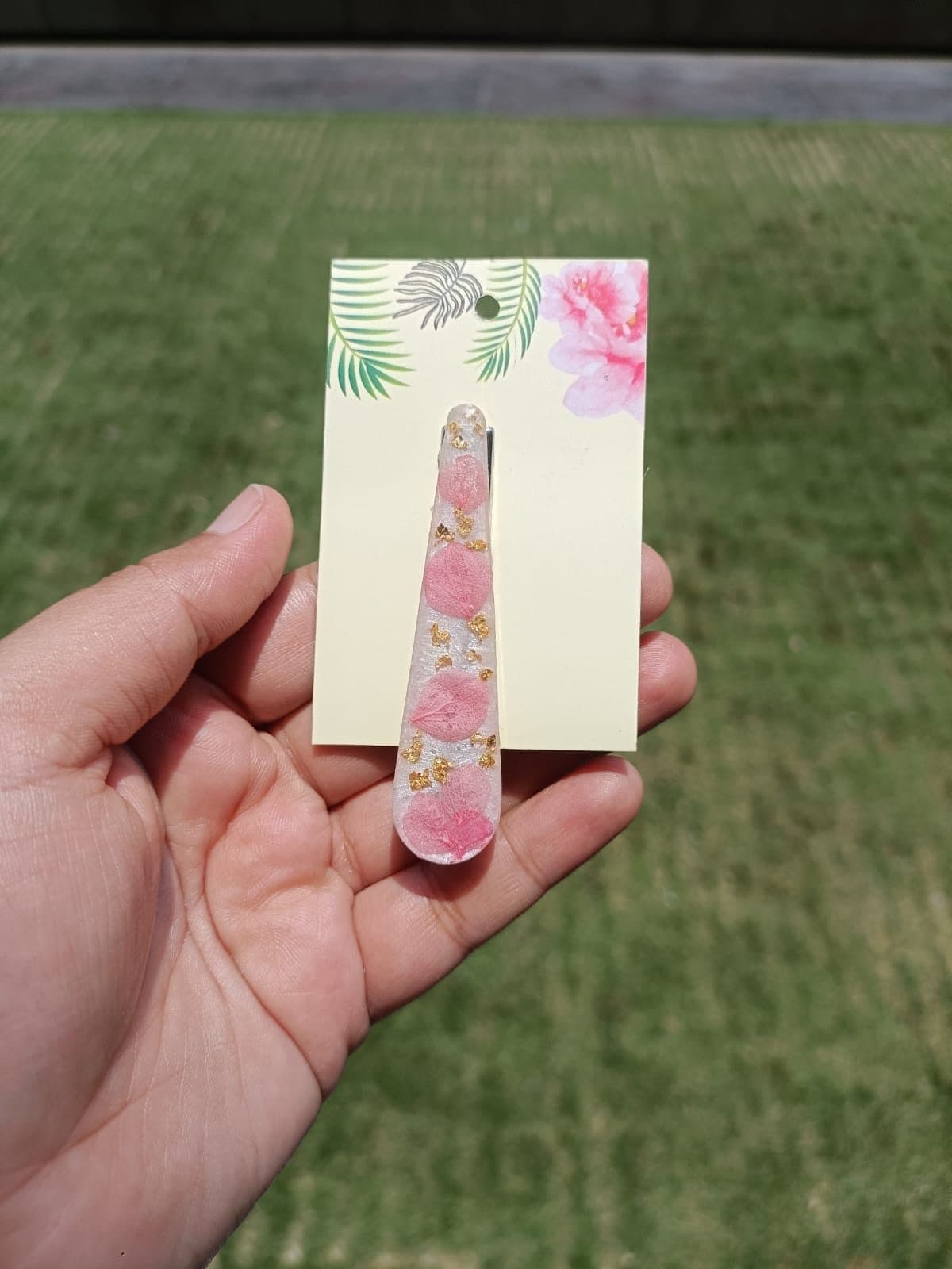 Resin bookmark with pressed pink petals and gold flakes