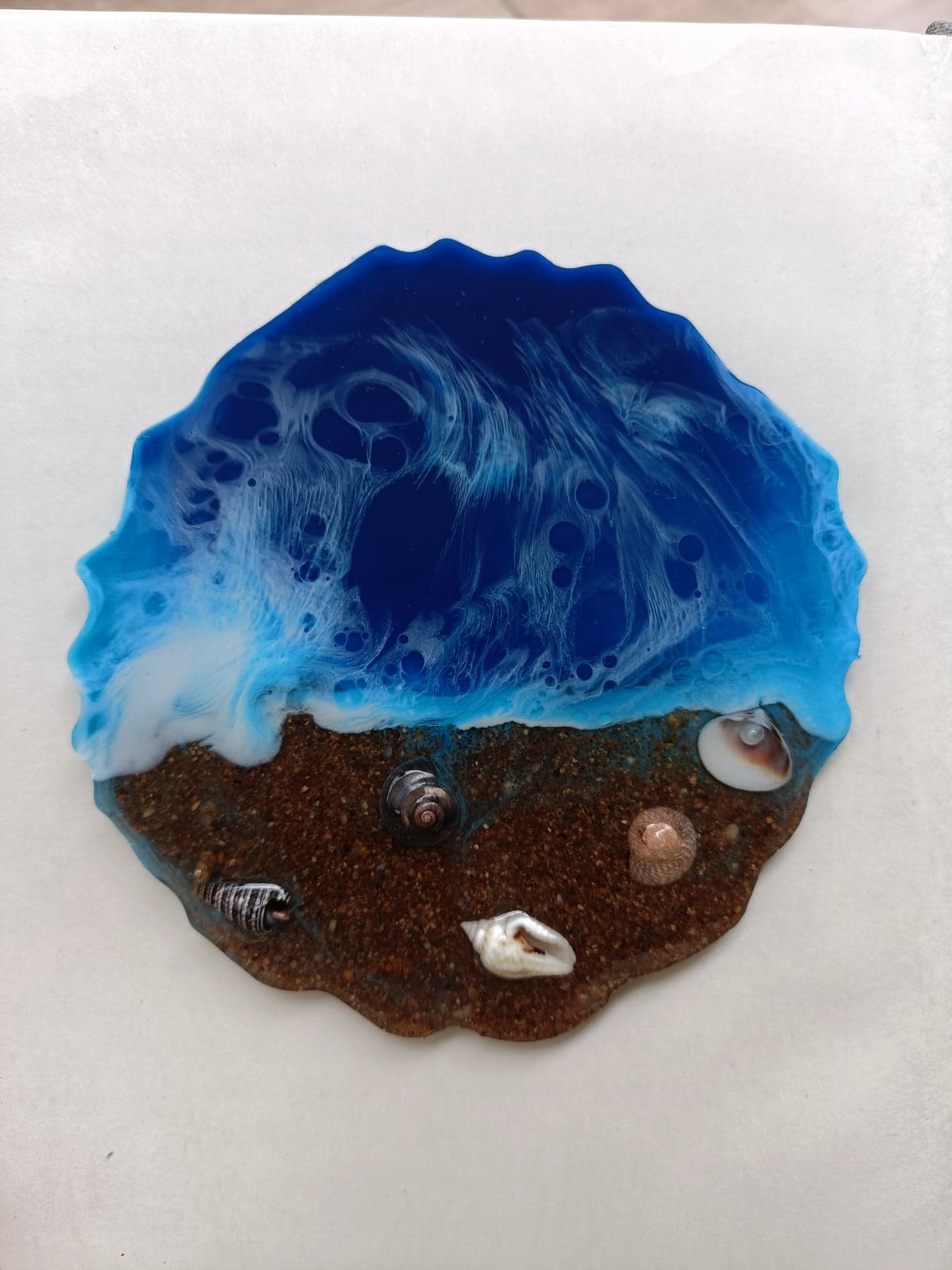 Ocean wave resin coaster with sand texture and seashells