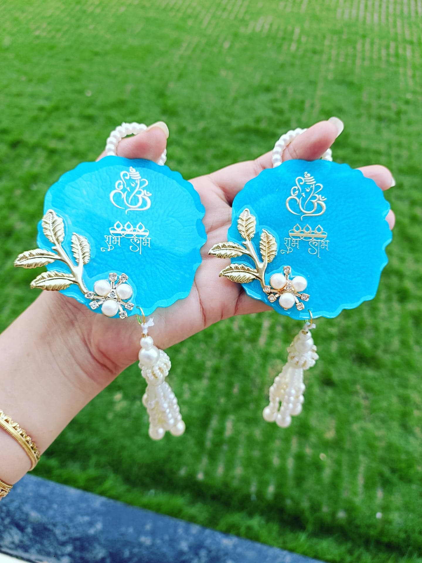 Pair of blue resin Shubh Labh hangings with pearls and tassels