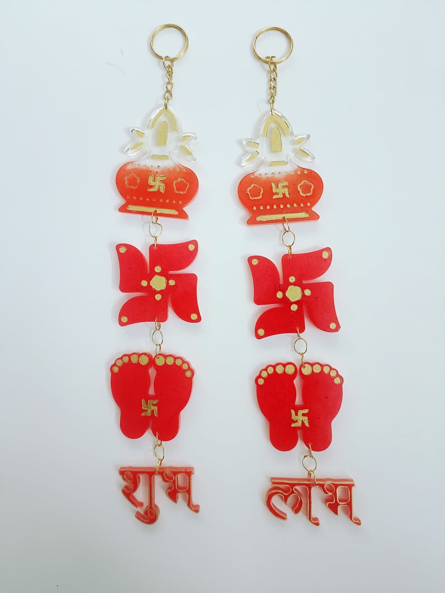 Pair of red resin hangings with kalash, swastik, footprints and Shubh Labh