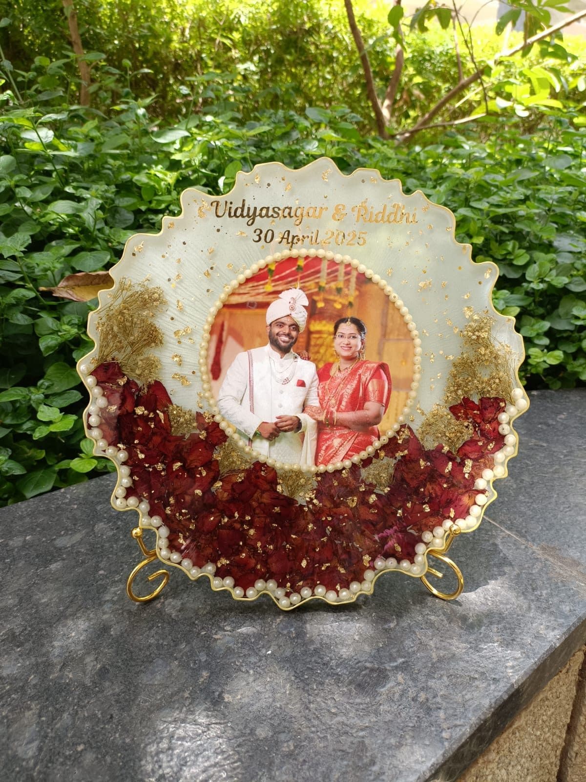 Scalloped resin plaque with Vidyasagar and Riddhi's wedding photograph, rose petals and pearls